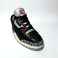 hand-painted black sneaker candle on white background.