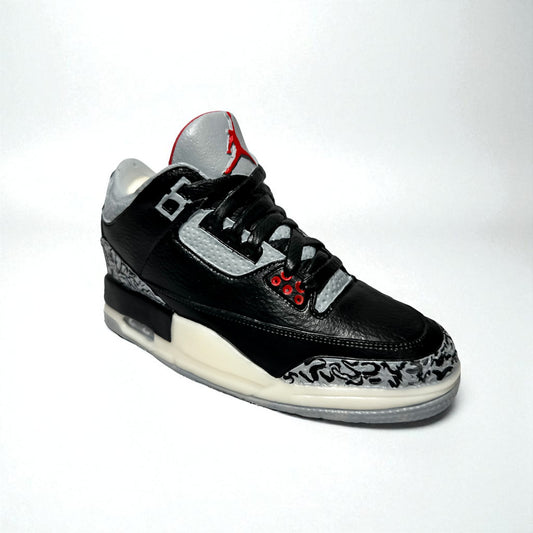 black cement 3 sneaker candle on white backdrop