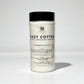 Plastic Clear Cylindrical Container of 'Cozy Cotton' deodorizing powder with a black lid on a white background